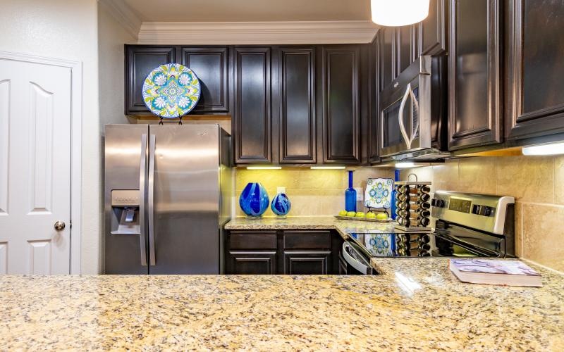 a kitchen with black cabinets