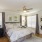 a bedroom with a bed and a fan