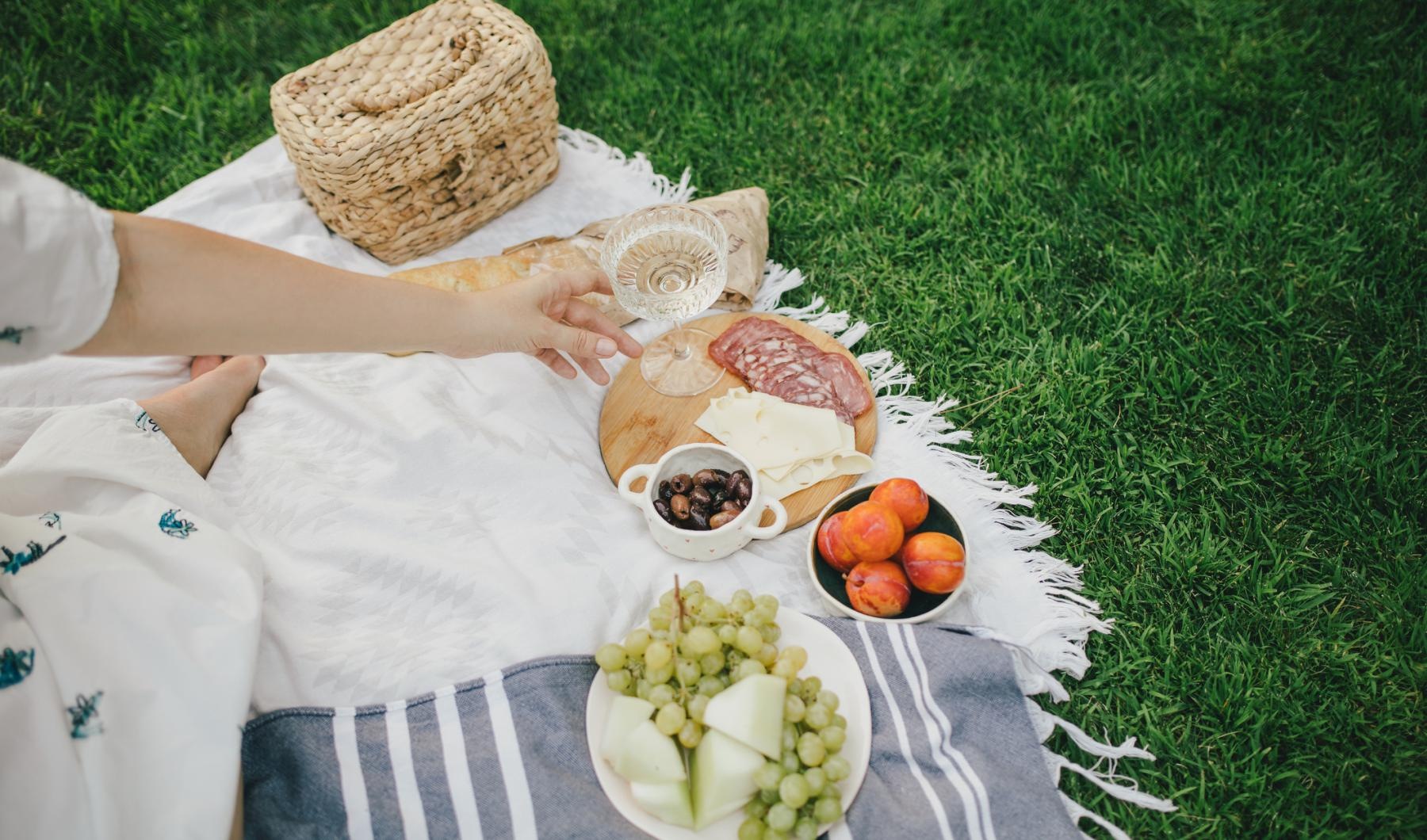Bustling community with plenty of dining choices a person sitting on a blanket with food on it