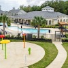 a pool and a playground with a building in the background