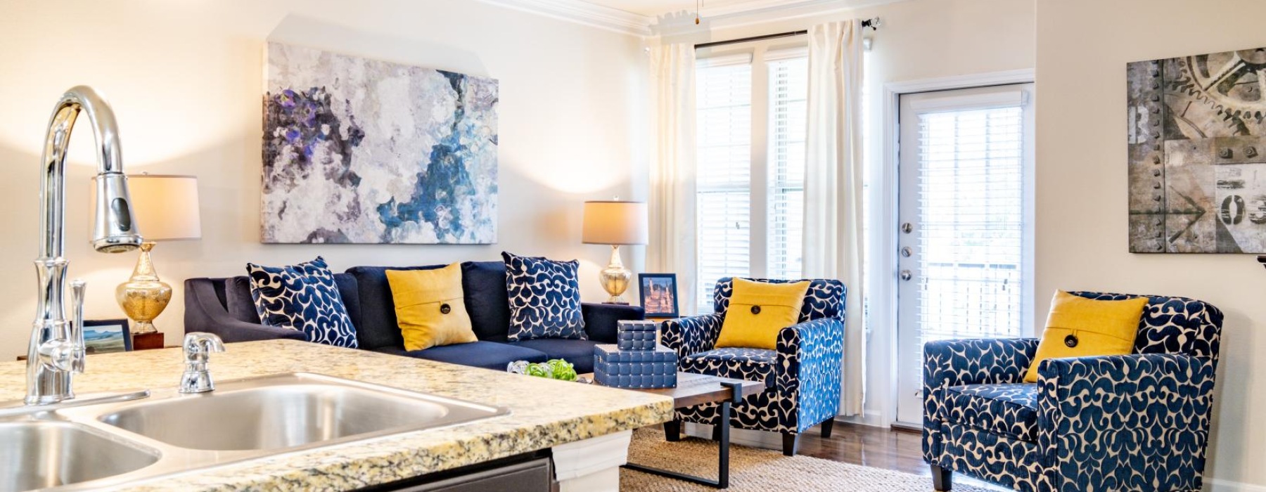 a living room with a sink and a couch