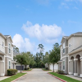 Find your perfect fit at Villages of Magnolia a street with trees and buildings on the side