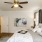 a bedroom with a bed and a fan