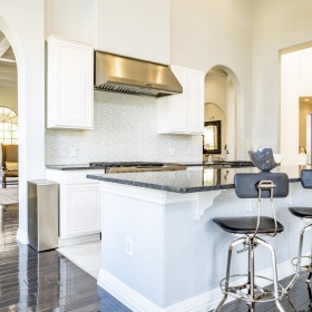 State-of-the-art amenities a community kitchen with a bar and chairs